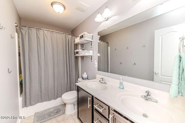 full bath with double vanity, toilet, shower / bath combo with shower curtain, and a sink