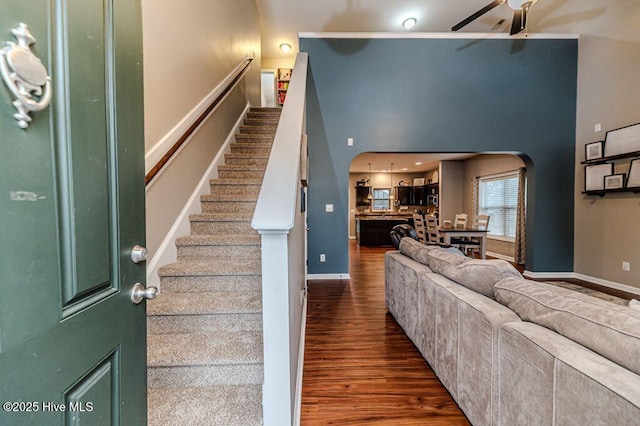 113 Sedgewood Ct, Aberdeen, NC 28315 - living area featuring arched walkways, stairway, dark wood-style floors, and a ceiling fan