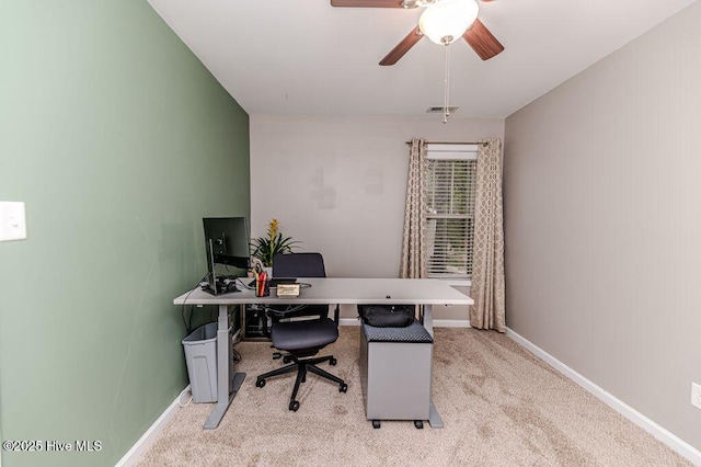 home office featuring light carpet, visible vents, ceiling fan, and baseboards