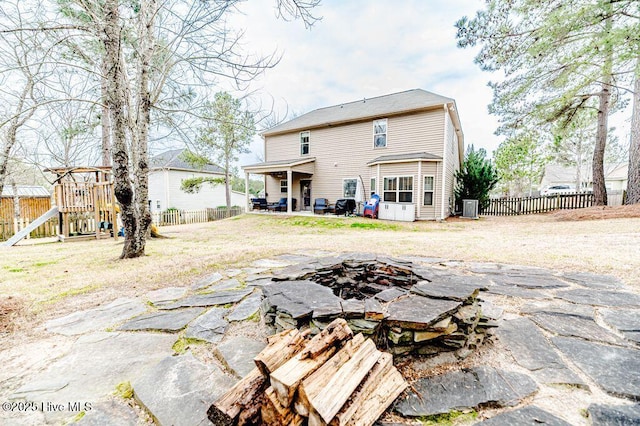 113 Sedgewood Ct, Aberdeen, NC 28315 - rear view of house featuring a fenced backyard, a playground, a fire pit, and a patio
