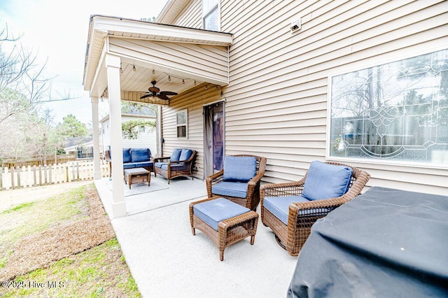 view of patio featuring outdoor lounge area, ceiling fan, and fence