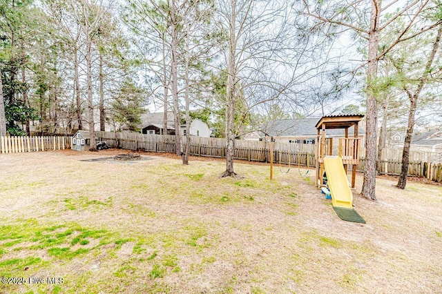 view of yard with a playground and a fenced backyard