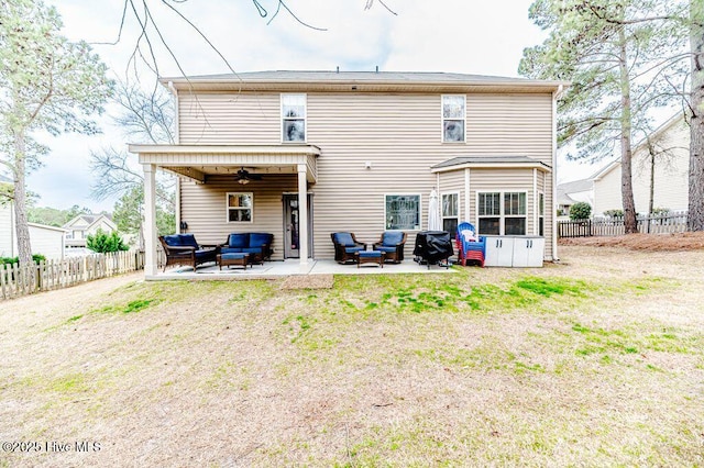 rear view of property featuring a fenced backyard, an outdoor hangout area, ceiling fan, and a patio