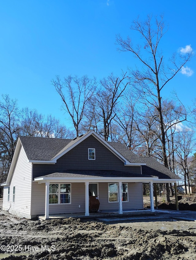 view of front of property featuring covered porch and roof with shingles