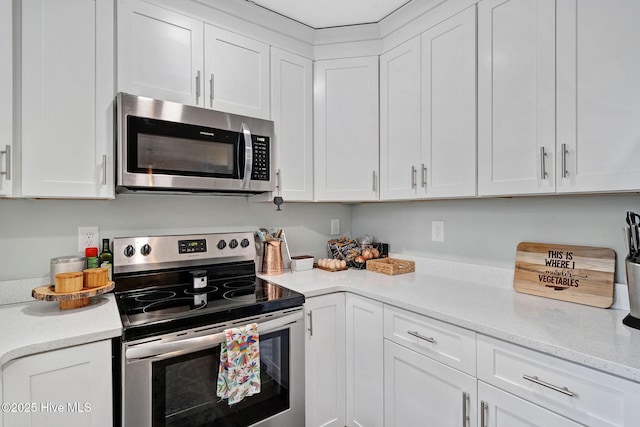 kitchen with appliances with stainless steel finishes and white cabinetry