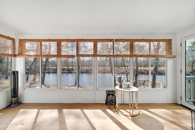 unfurnished sunroom with a water view