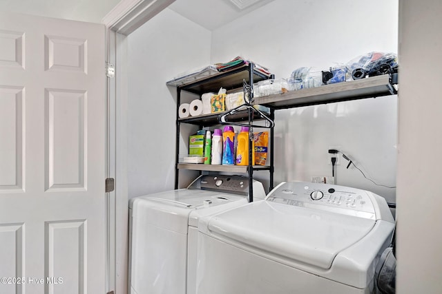 clothes washing area with washing machine and dryer and laundry area