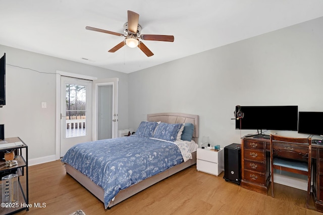 bedroom with a ceiling fan, wood finished floors, visible vents, and baseboards