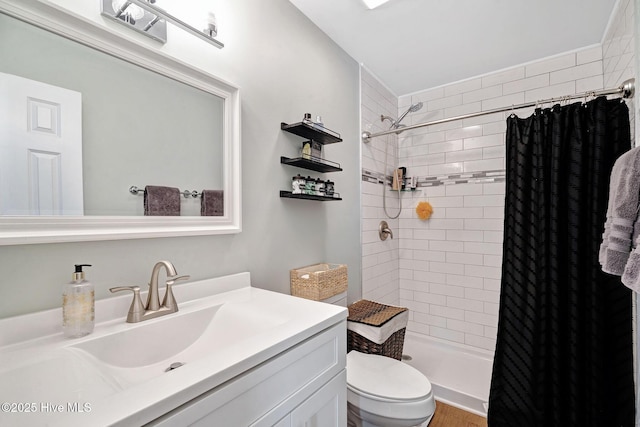 full bathroom featuring vanity, toilet, and a stall shower