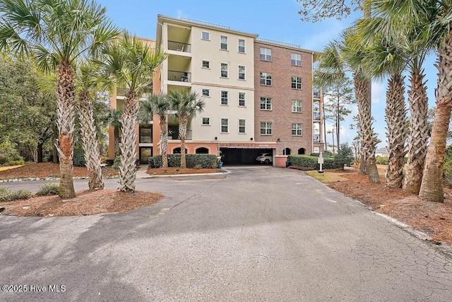 view of property with aphalt driveway