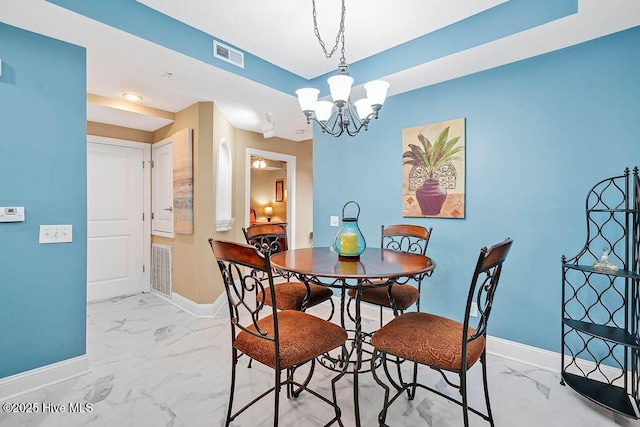 dining area featuring visible vents, baseboards, a notable chandelier, and marble finish floor