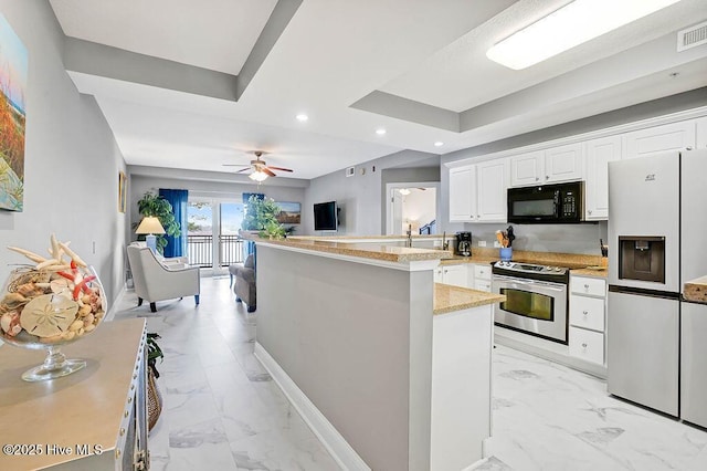 kitchen featuring electric range, marble finish floor, white fridge with ice dispenser, and black microwave