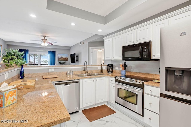 kitchen with a ceiling fan, a sink, recessed lighting, stainless steel appliances, and white cabinets