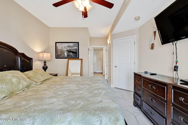 bedroom with marble finish floor and a ceiling fan