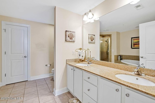 bathroom featuring a sink, visible vents, a stall shower, and tile patterned floors