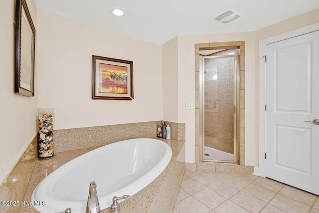 bathroom with tile patterned flooring, a shower stall, a bath, and visible vents