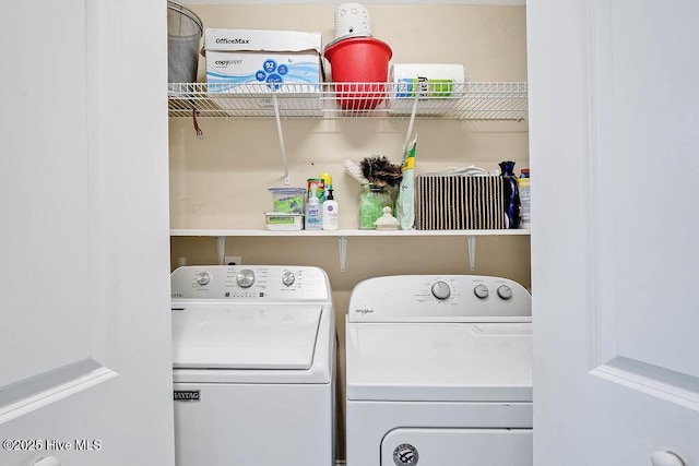 clothes washing area with washing machine and dryer and laundry area