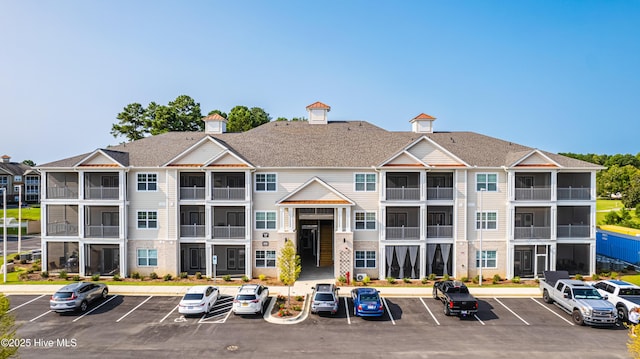 view of building exterior featuring uncovered parking