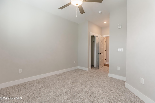 unfurnished bedroom with baseboards, recessed lighting, ceiling fan, a closet, and light colored carpet