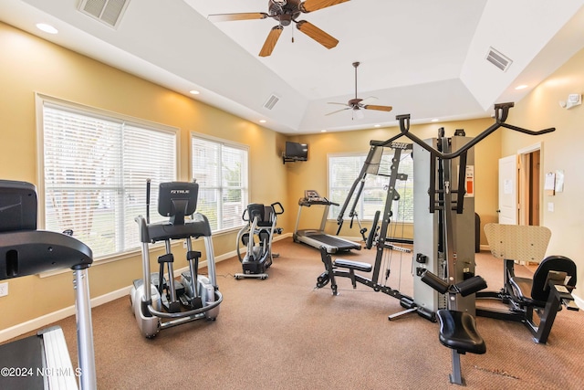 workout area with a raised ceiling, recessed lighting, baseboards, and visible vents