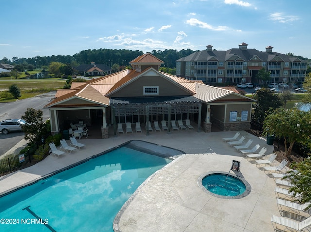 community pool featuring a patio and a community hot tub