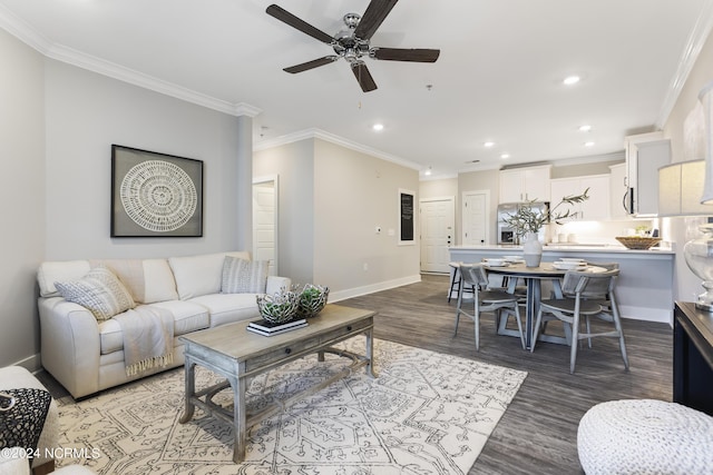 living area with a ceiling fan, wood finished floors, baseboards, recessed lighting, and ornamental molding