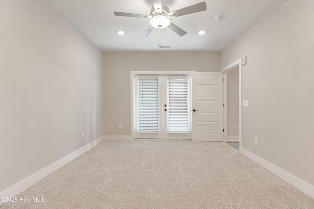 empty room with a ceiling fan, french doors, baseboards, and carpet floors