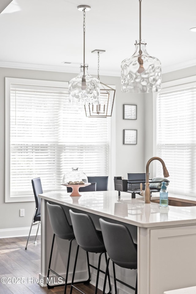 dining area featuring an inviting chandelier, crown molding, and a healthy amount of sunlight