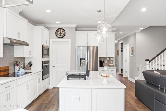 kitchen featuring under cabinet range hood, dark wood finished floors, light countertops, stainless steel appliances, and white cabinetry