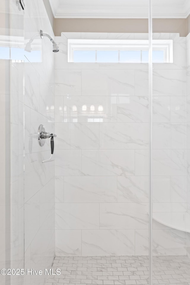 full bath featuring a stall shower and crown molding