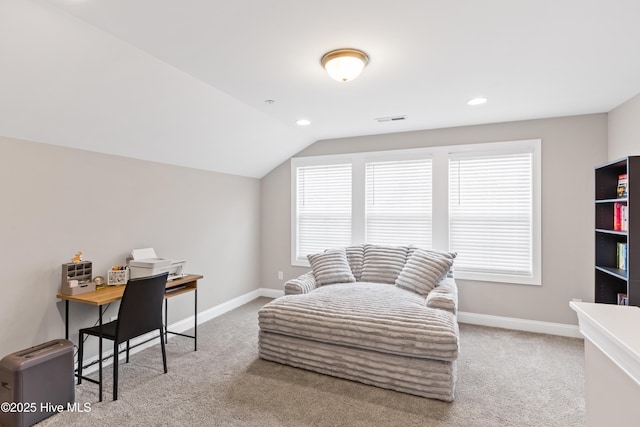 office space featuring visible vents, baseboards, carpet, and vaulted ceiling