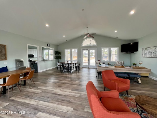 living area featuring a ceiling fan, wood finished floors, baseboards, lofted ceiling, and recessed lighting