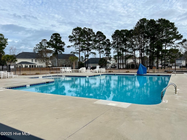 pool featuring a patio area and fence