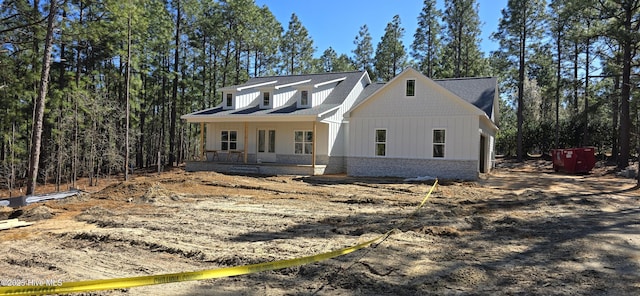 modern farmhouse featuring brick siding and board and batten siding