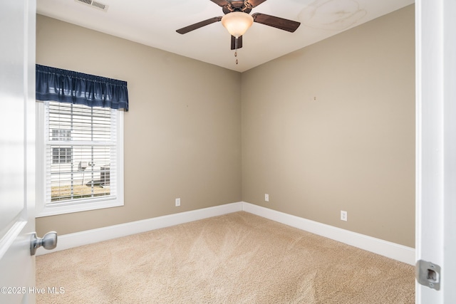 empty room featuring visible vents, baseboards, ceiling fan, and carpet floors