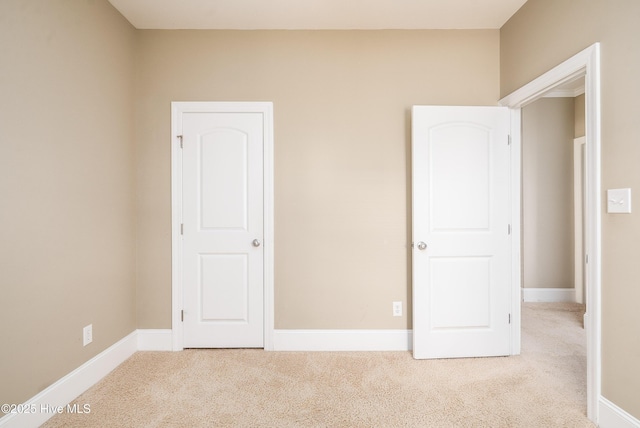 unfurnished bedroom with baseboards and carpet floors