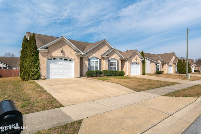 ranch-style house with brick siding, an attached garage, and concrete driveway