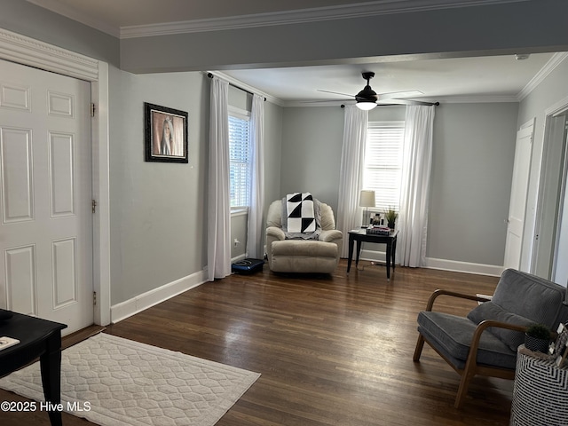 sitting room with crown molding, a ceiling fan, dark wood-type flooring, and baseboards