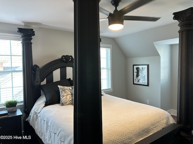 bedroom featuring baseboards, lofted ceiling, and a ceiling fan