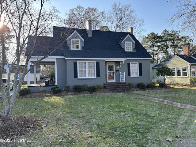 cape cod house with a front yard, a patio area, roof with shingles, and a chimney