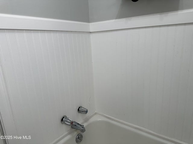 room details featuring tub / shower combination