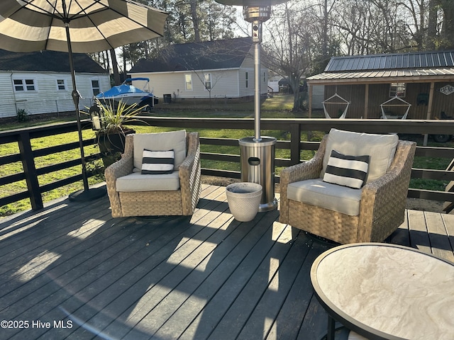 wooden terrace with a residential view and a lawn