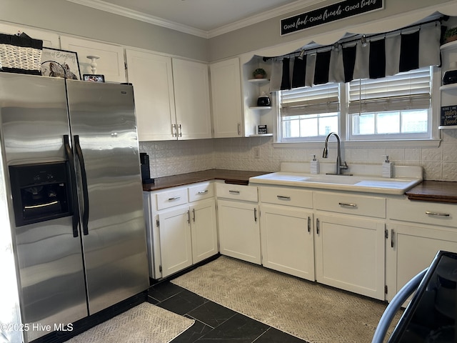 kitchen featuring ornamental molding, decorative backsplash, white cabinets, stainless steel fridge, and open shelves