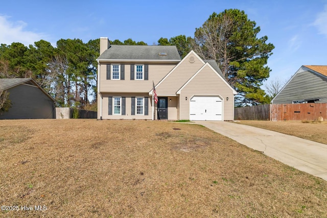 colonial home with fence, driveway, a chimney, a front lawn, and a garage