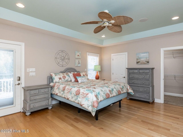 129 Sunset Dr, Cedar Point, NC 28584 - bedroom featuring access to exterior, recessed lighting, a tray ceiling, and light wood finished floors