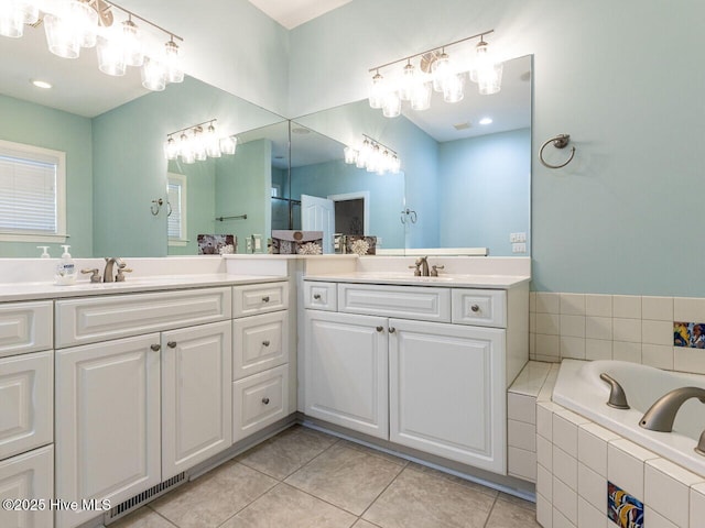 129 Sunset Dr, Cedar Point, NC 28584 - full bath with tile patterned flooring, a sink, visible vents, and two vanities