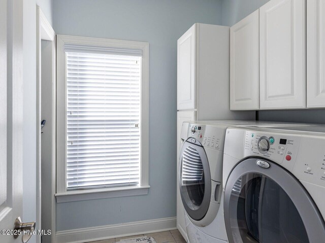 129 Sunset Dr, Cedar Point, NC 28584 - washroom with washing machine and clothes dryer, tile patterned flooring, cabinet space, and baseboards