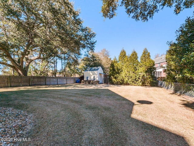 129 Sunset Dr, Cedar Point, NC 28584 - view of yard featuring an outdoor structure and a fenced backyard
