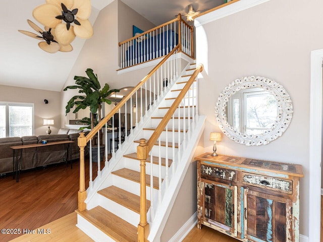 129 Sunset Dr, Cedar Point, NC 28584 - stairway with baseboards, high vaulted ceiling, ceiling fan, and wood finished floors
