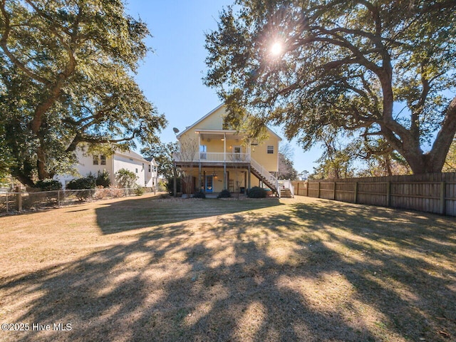 129 Sunset Dr, Cedar Point, NC 28584 - back of house featuring a yard, stairs, and a fenced backyard